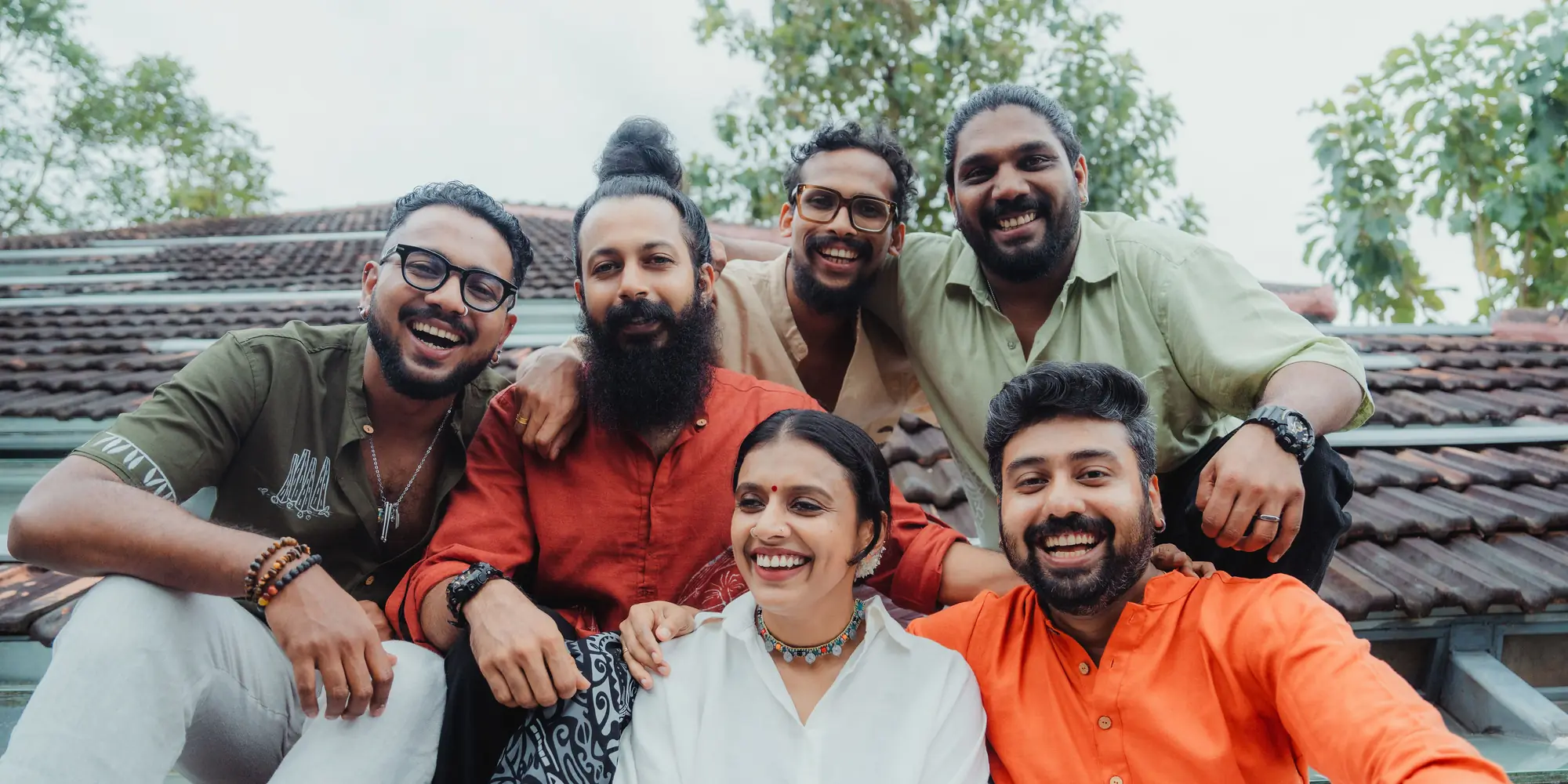 Sithara Krishnakumar and the six members of Project Malabaricus on a tiled rooftop